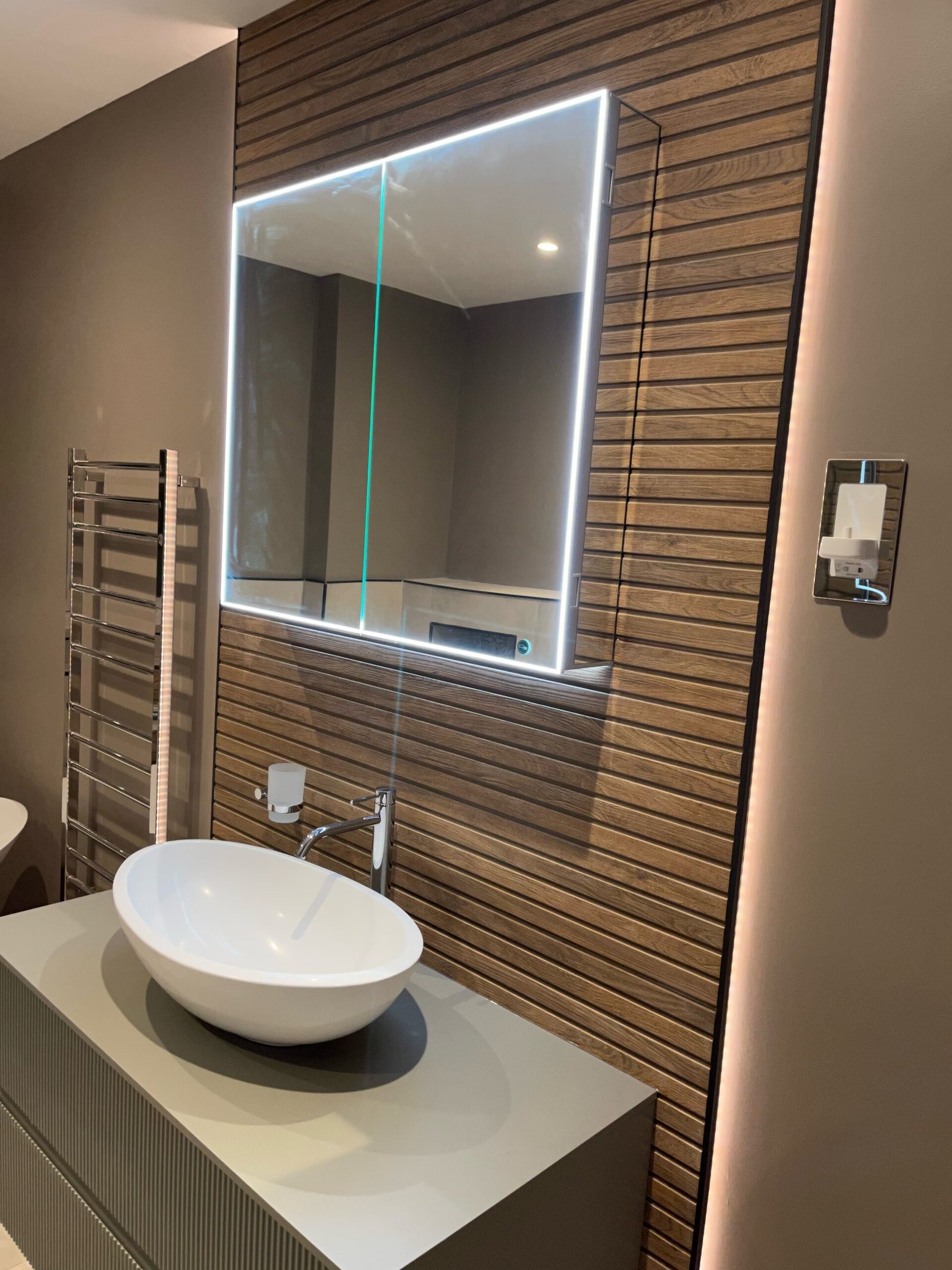 Luxury bathroom vanity with LED mirror and vessel sink in Weybridge by Summer Plumbing